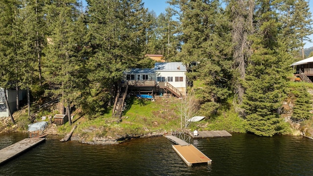 view of dock with a deck with water view and stairs