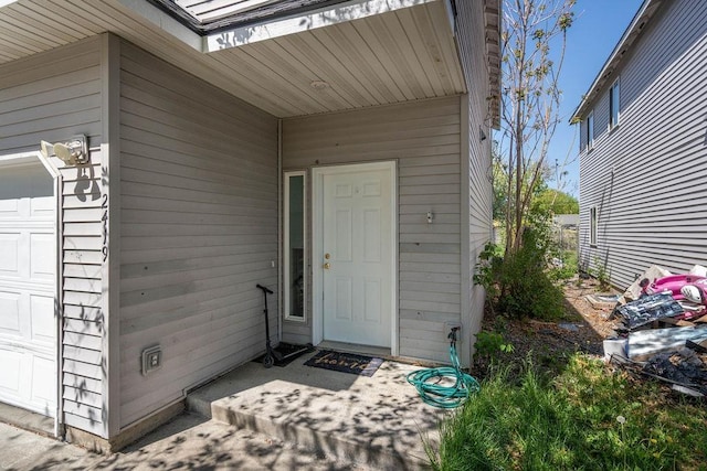 doorway to property featuring a garage