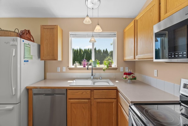 19322 E Indiana Ave, Greenacres, WA 99016 - kitchen featuring a sink, stainless steel appliances, light countertops, and pendant lighting
