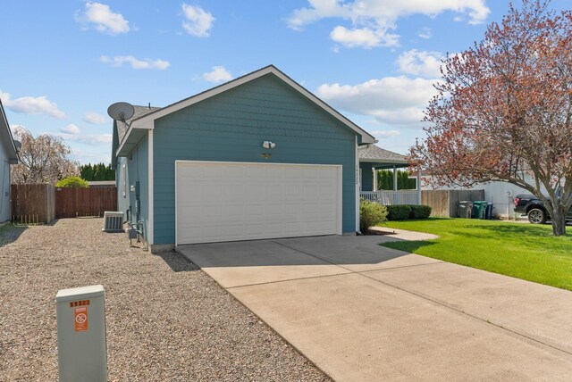 19322 E Indiana Ave, Greenacres, WA 99016 - view of side of home with an attached garage, concrete driveway, fence, and cooling unit