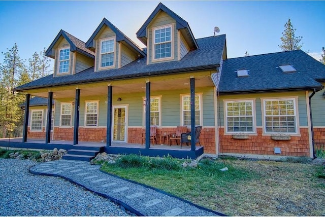 view of front of home with a porch and a shingled roof