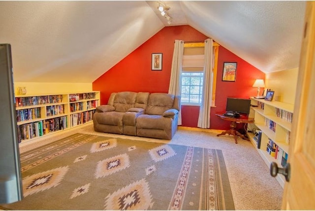 sitting room featuring carpet floors and vaulted ceiling