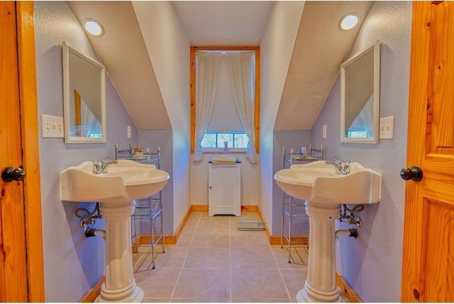bathroom featuring baseboards and tile patterned flooring