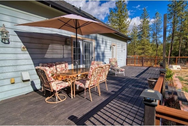 wooden terrace featuring outdoor dining space