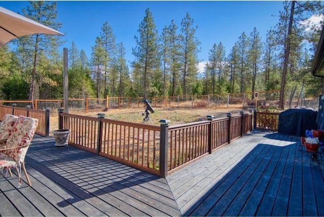 wooden deck featuring a fenced backyard