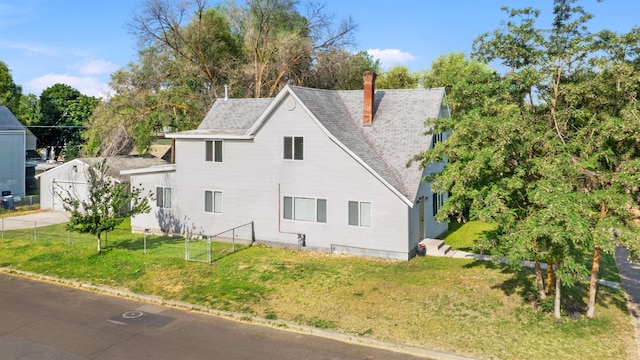 1801 W Sharp Ave, Spokane, WA 99201 - view of side of property featuring a chimney and a shingled roof