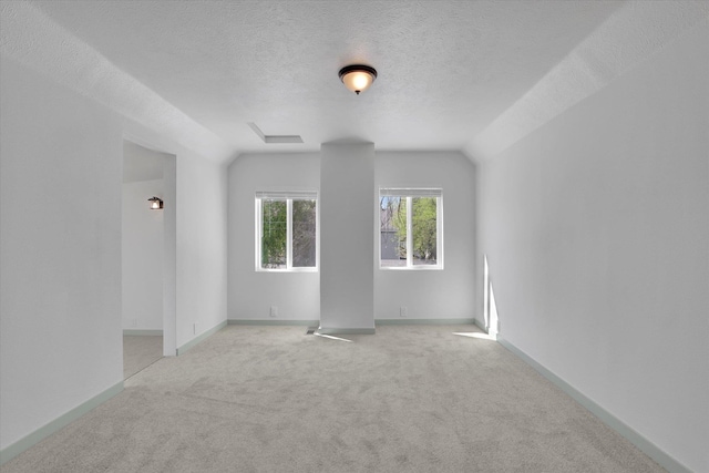1801 W Sharp Ave, Spokane, WA 99201 - spare room with light carpet, a textured ceiling, and vaulted ceiling