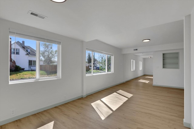 1801 W Sharp Ave, Spokane, WA 99201 - empty room with plenty of natural light, light wood-style flooring, and built in features