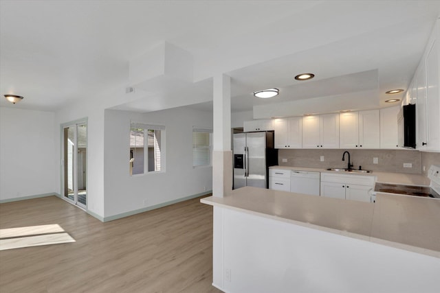 1801 W Sharp Ave, Spokane, WA 99201 - kitchen featuring stainless steel fridge, white dishwasher, range, white cabinets, and light wood-style flooring