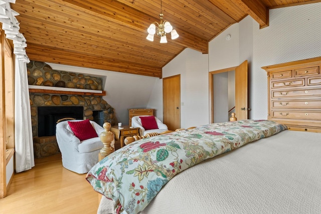 3247 Jumpoff Way, Valley, WA 99181 - bedroom with light wood-type flooring, a fireplace, an inviting chandelier, wood ceiling, and vaulted ceiling with beams