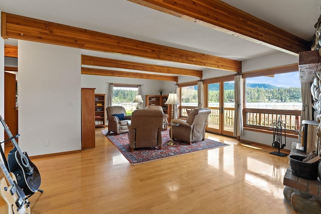3247 Jumpoff Way, Valley, WA 99181 - living area featuring light wood finished floors, baseboards, and beam ceiling