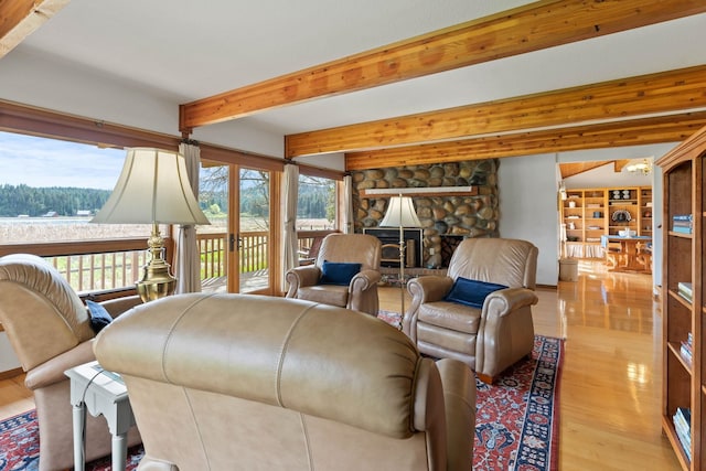 3247 Jumpoff Way, Valley, WA 99181 - living area with a fireplace, beamed ceiling, a healthy amount of sunlight, and wood finished floors
