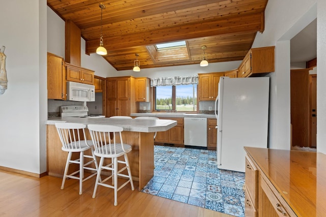 3247 Jumpoff Way, Valley, WA 99181 - kitchen featuring a peninsula, lofted ceiling with skylight, white appliances, light countertops, and wooden ceiling