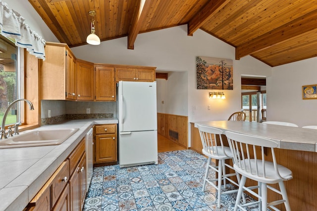 3247 Jumpoff Way, Valley, WA 99181 - kitchen with a sink, lofted ceiling with beams, freestanding refrigerator, a breakfast bar area, and wood ceiling