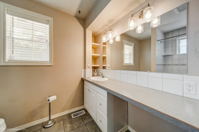 4023 W Hoffman Ave, Spokane, WA 99205 - full bathroom with baseboards, visible vents, tiled shower, tile patterned floors, and vanity