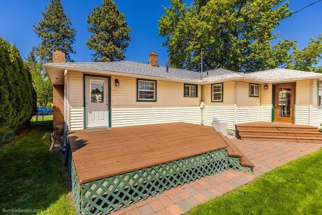 4023 W Hoffman Ave, Spokane, WA 99205 - rear view of property featuring a lawn, a chimney, and a wooden deck