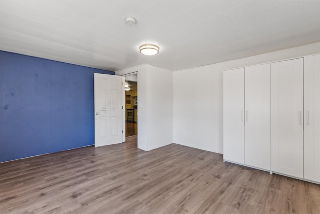 unfurnished bedroom featuring a closet and wood finished floors