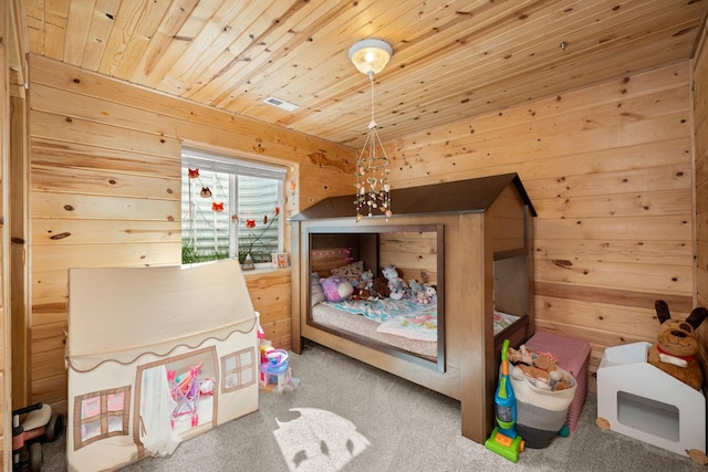 bedroom featuring wooden ceiling, wood walls, and carpet floors