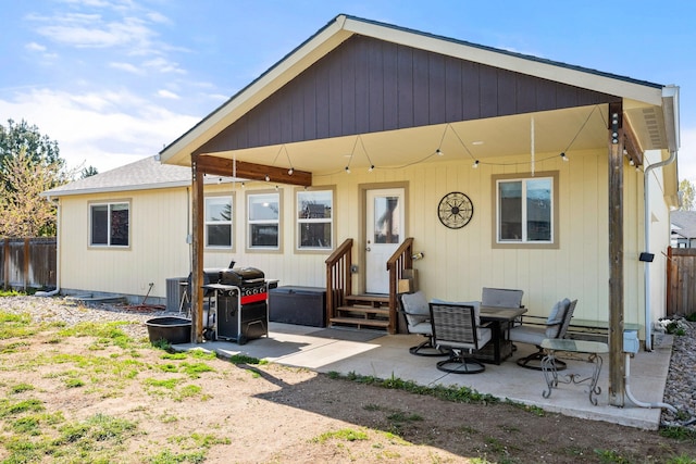 rear view of property featuring a patio area, fence, entry steps, and central AC unit