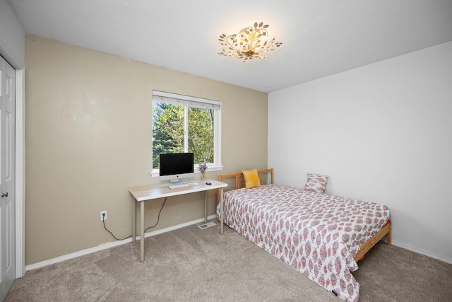 bedroom with baseboards, visible vents, and carpet
