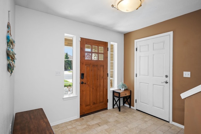 foyer featuring baseboards