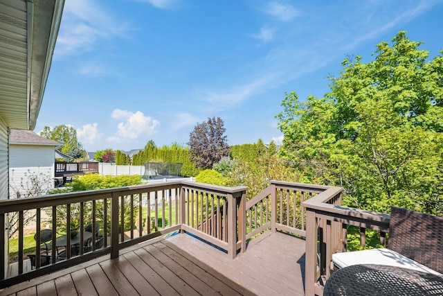 wooden deck featuring a trampoline