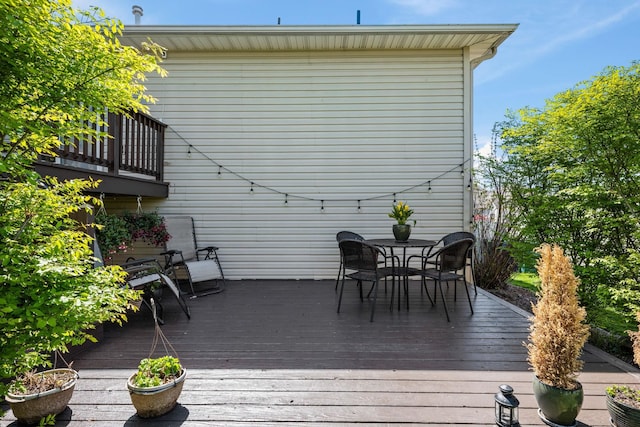 wooden terrace featuring outdoor dining area