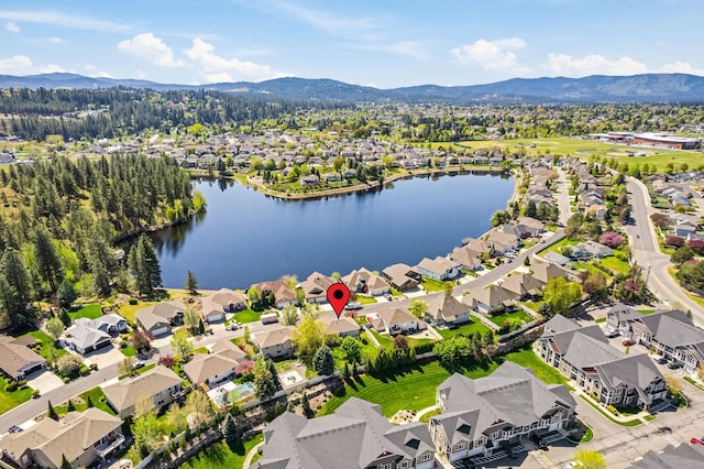 drone / aerial view with a residential view and a water and mountain view