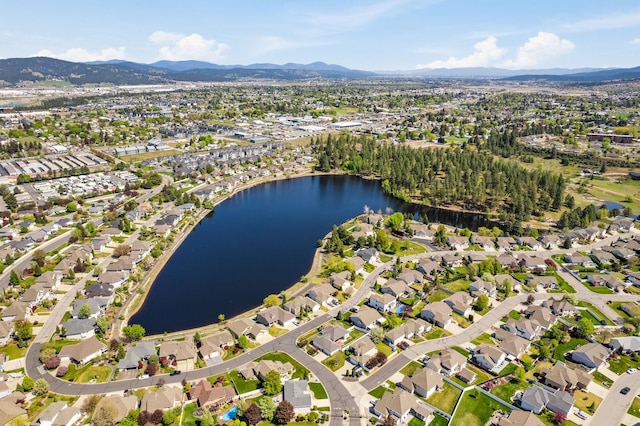 drone / aerial view featuring a water and mountain view and a residential view
