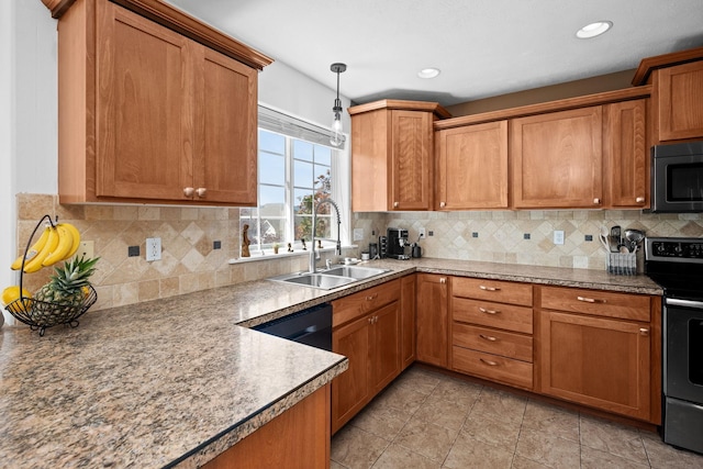 kitchen featuring hanging light fixtures, brown cabinets, a sink, and electric range
