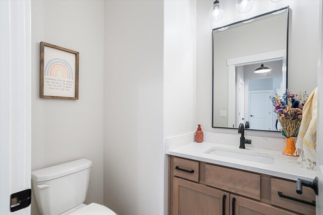 half bath with vanity and toilet