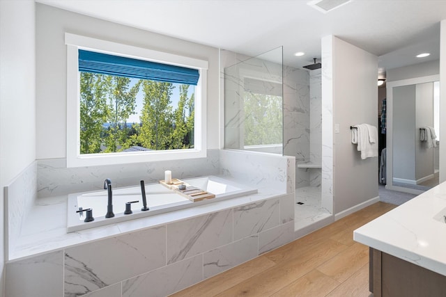 full bathroom with wood finished floors, a marble finish shower, visible vents, recessed lighting, and a garden tub