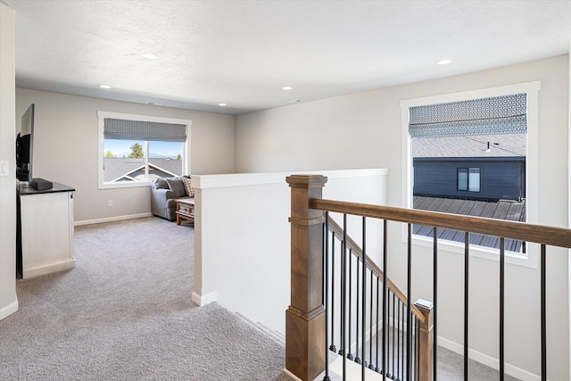 hall featuring baseboards, an upstairs landing, recessed lighting, and carpet floors