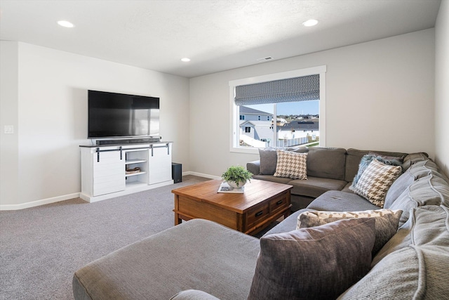 carpeted living area featuring baseboards, visible vents, and recessed lighting