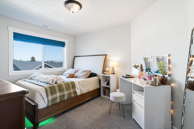 bedroom with visible vents and carpet