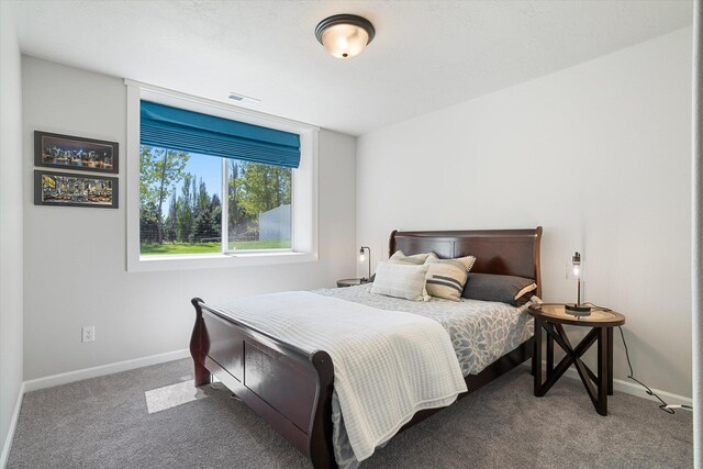 carpeted bedroom featuring visible vents and baseboards