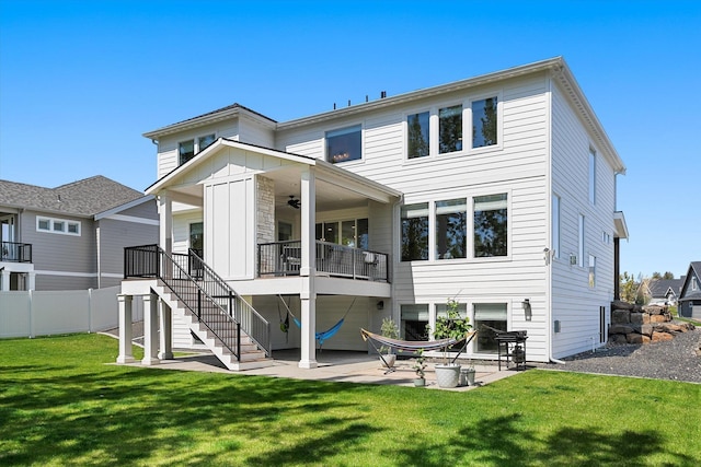 back of property with stairs, fence, a yard, a patio, and ceiling fan