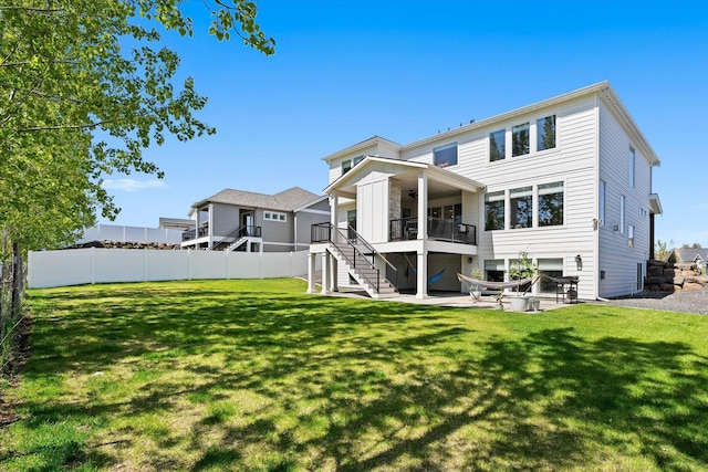 back of house featuring a ceiling fan, a yard, fence, stairs, and a patio area