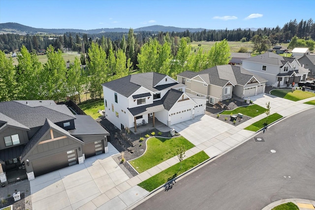 aerial view with a view of trees, a mountain view, and a residential view