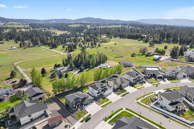 bird's eye view with a wooded view, a residential view, and a mountain view