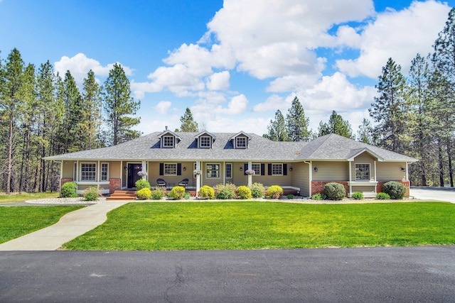 21724 N Perry Rd, Colbert, WA 99005 - new england style home with covered porch, a shingled roof, brick siding, and a front lawn