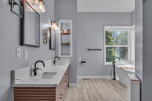 21724 N Perry Rd, Colbert, WA 99005 - bathroom with a soaking tub, double vanity, baseboards, and a sink