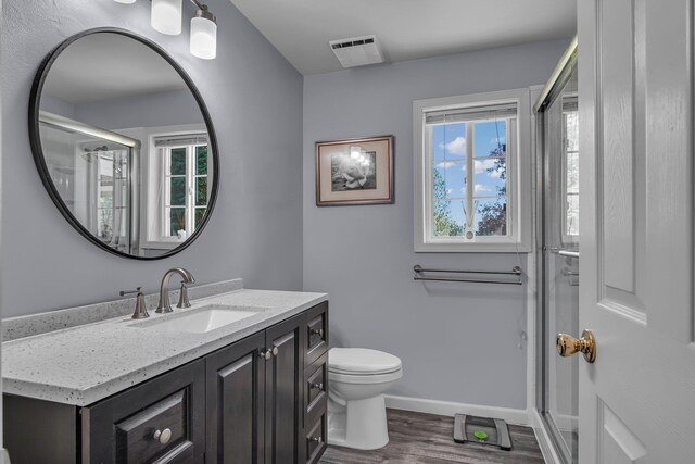 21724 N Perry Rd, Colbert, WA 99005 - full bathroom with toilet, a wealth of natural light, visible vents, and wood finished floors