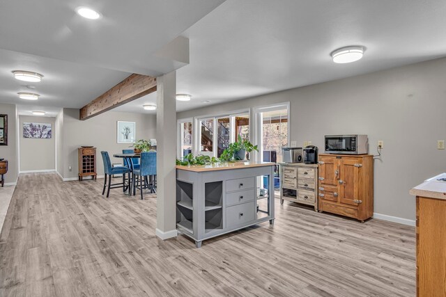 21724 N Perry Rd, Colbert, WA 99005 - kitchen with stainless steel microwave, beamed ceiling, baseboards, and light wood-type flooring