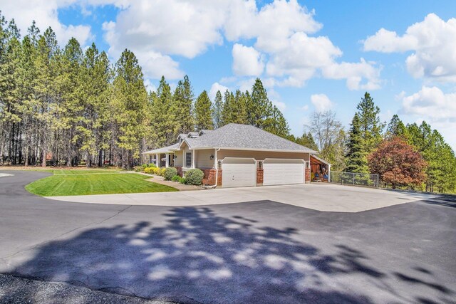 21724 N Perry Rd, Colbert, WA 99005 - view of front of home featuring fence, brick siding, driveway, a garage, and a front yard
