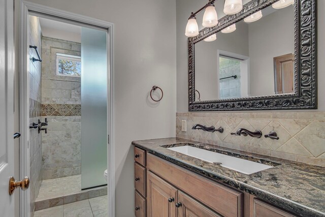 21724 N Perry Rd, Colbert, WA 99005 - bathroom with vanity, toilet, tasteful backsplash, and a tile shower