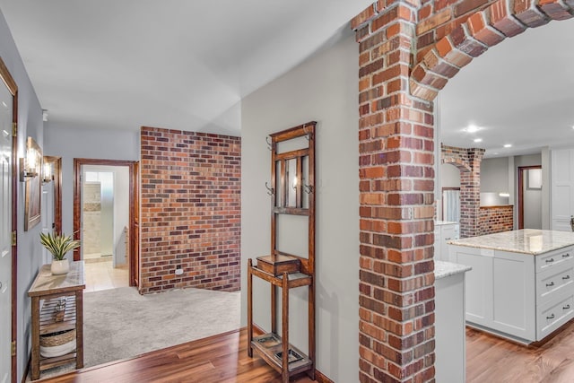 21724 N Perry Rd, Colbert, WA 99005 - hallway featuring decorative columns, recessed lighting, light wood finished floors, arched walkways, and brick wall