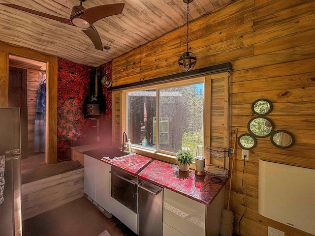 kitchen featuring a sink, decorative light fixtures, wooden ceiling, ceiling fan, and white cabinets