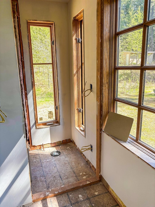 spare room with baseboards and stone finish floor