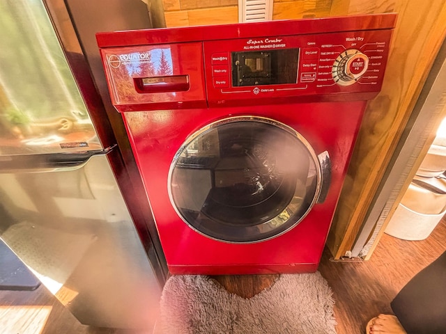 washroom with wood finished floors and washer / clothes dryer